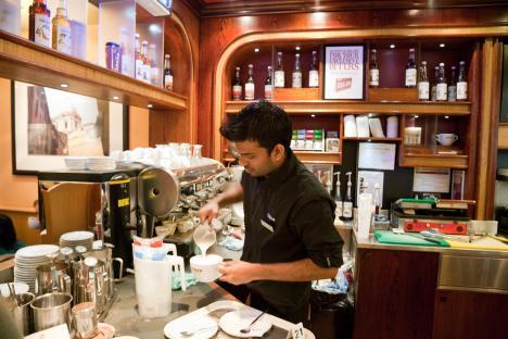 Barista making coffee in a Costa Coffee shop.