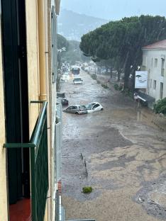 Cars submerged in floodwaters during a rainstorm.