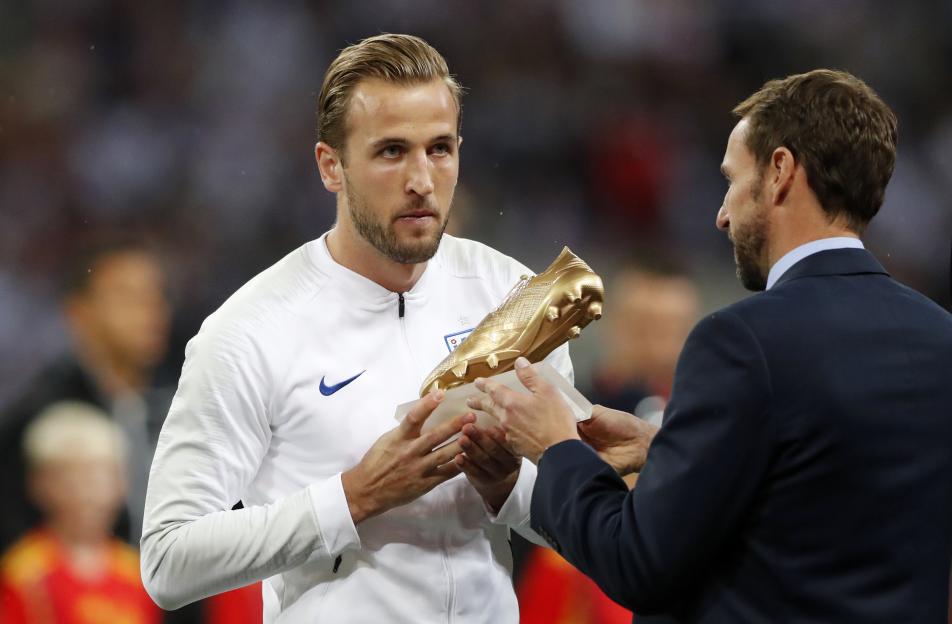 England manager Gareth Southgate hands Harry Kane his World Cup Golden Boot.