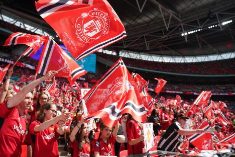 Manchester United fans waving flags at a stadium.