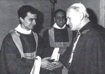 Black and white photo of Pope John Paul II shaking hands with newly ordained Rev. Robert Francis Prevost.