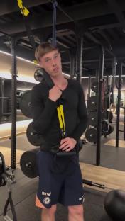 Cole Palmer in a gym, holding resistance straps.