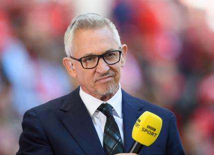 Gary Lineker, BBC TV presenter, holding a microphone.