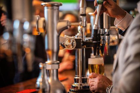 Bartender pouring beer in a pub.