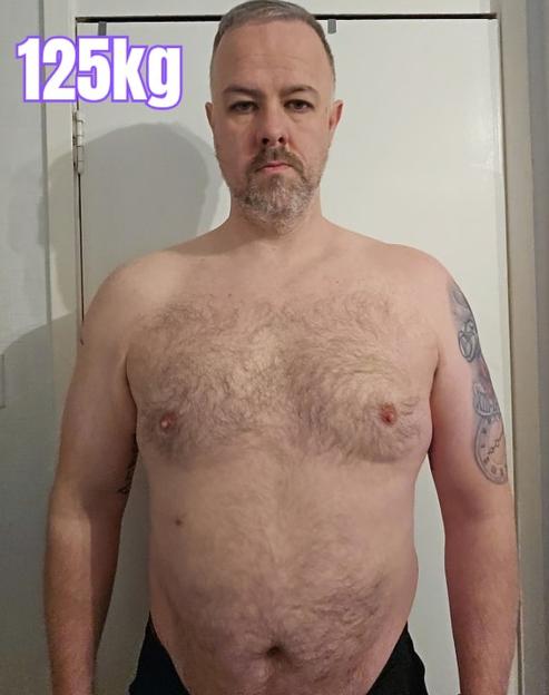 A shirtless man, with the number "125kg" overlaid in purple on the top left.