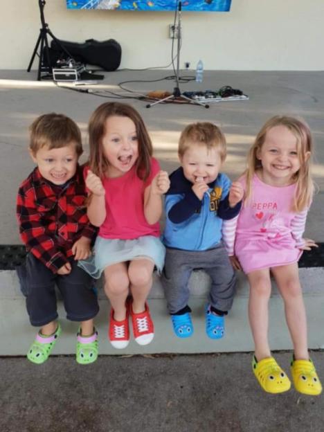 Four young children sitting together.