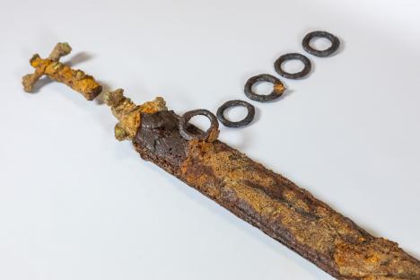 Rusty metal sword and rings.