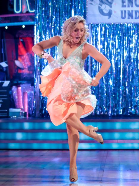 Amy Dowden dancing in a pale peach dress on Strictly Come Dancing.