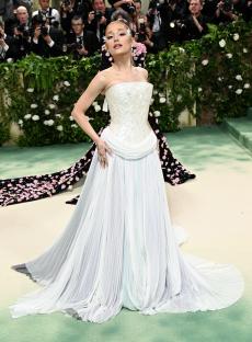 Ariana Grande at the Met Gala in a white pleated gown.