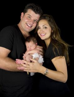Parents holding their newborn baby.