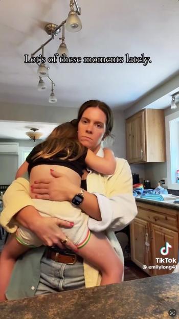 A woman holding a young child in her arms.