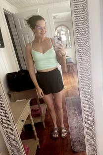 Woman taking a selfie in a mirror after weight loss.