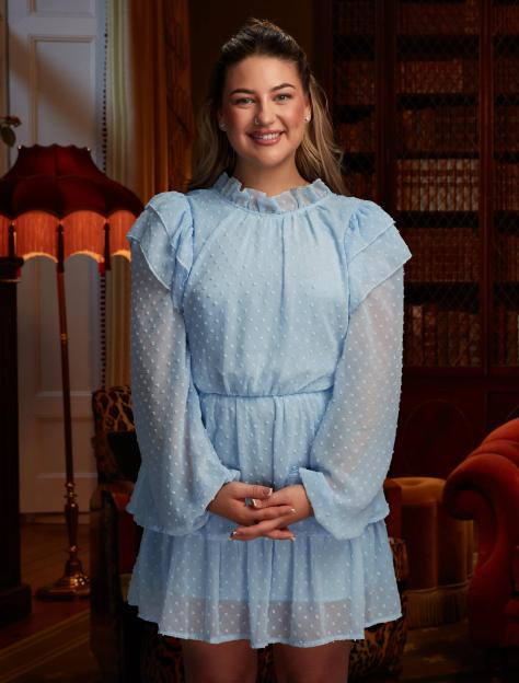 Portrait of a woman in a light blue dress.