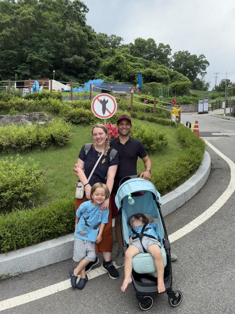 Family posing near a no-missile sign at the North Korean border.