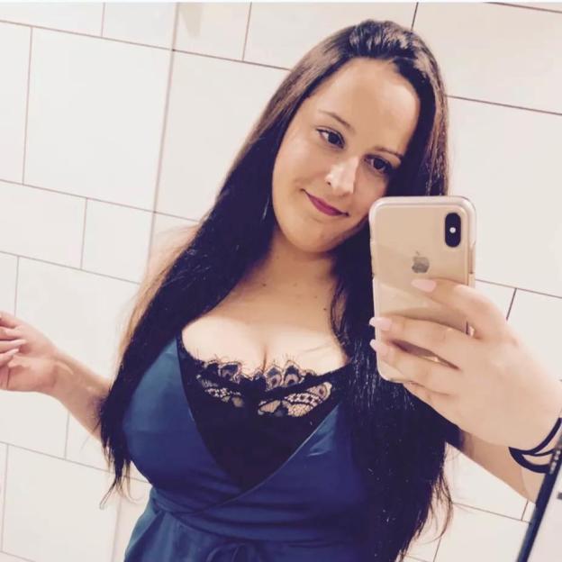 Selfie of a woman in a blue dress.