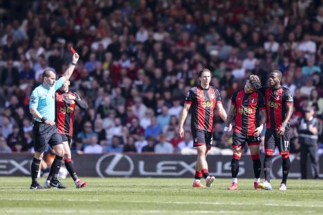 Referee showing a red card to a Bournemouth player.