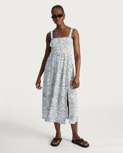 Woman wearing a white floral midi dress.