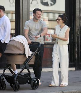 Michelle Keegan and Mark Wright with their baby in a stroller.