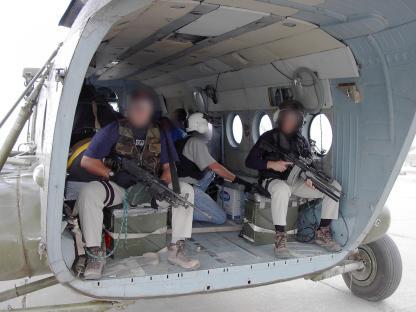 CIA operatives in a helicopter carrying cash to pay Afghan troops.