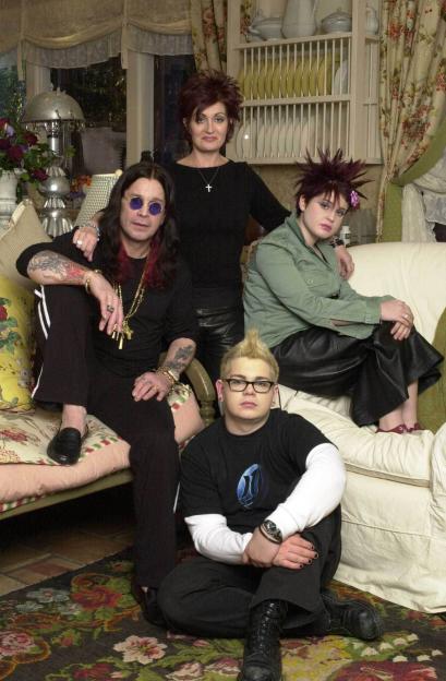 The Osbournes family, Ozzy, Sharon, Jack, and Kelly, in a living room.