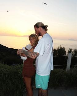 Diletta Leotta and Loris Karius with their baby at sunset.