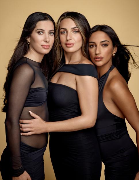 Portrait of three women in black dresses.