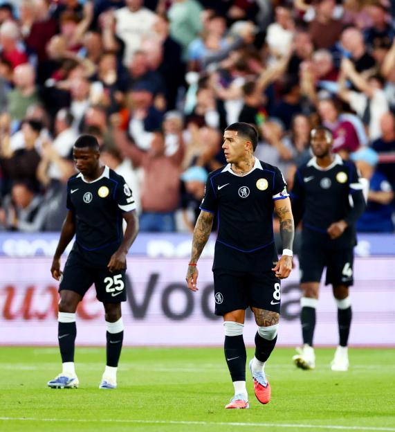 Chelsea players looking dejected on the field.