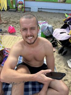 Photo of Nathan Osman on a beach.