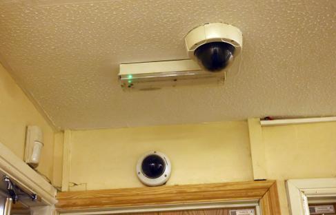 Security cameras and emergency light in a building.