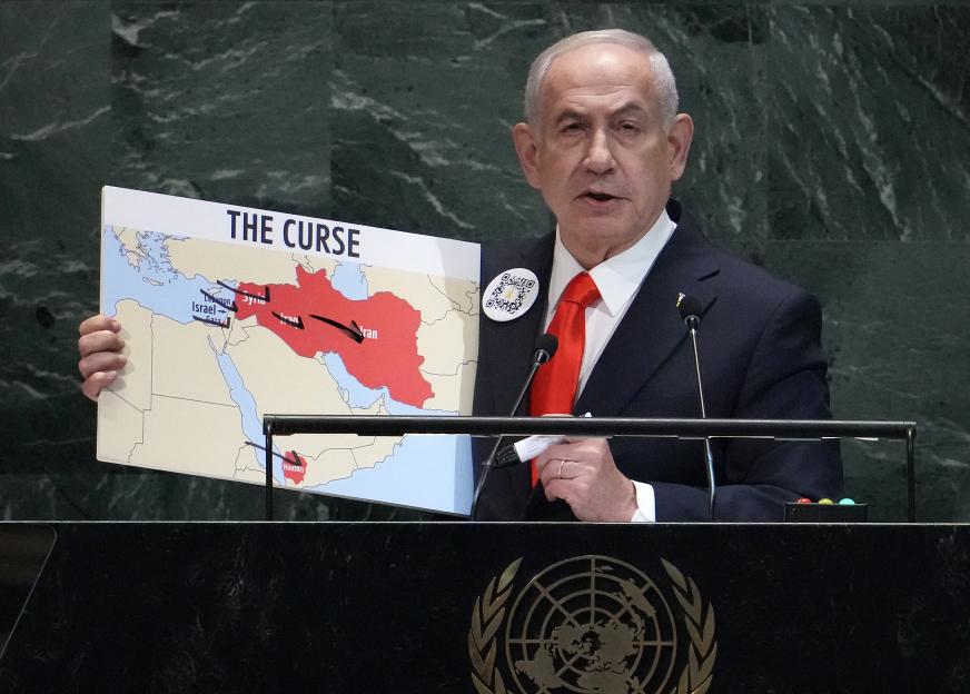 Israeli Prime Minister Benjamin Netanyahu holding a map titled "THE CURSE" during a speech at the United Nations.
