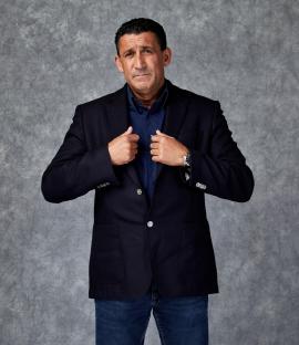 Portrait of Steven Gillen, ex-gangster, adjusting his jacket.
