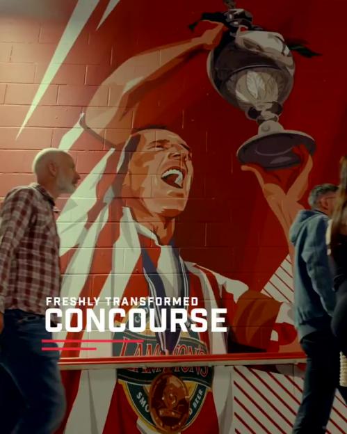 Illustration of a freshly transformed concourse at Sunderland's Stadium of Light, featuring a mural of a player lifting a trophy.