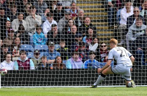 Soccer player Josh Coburn shoots wide of the goal.
