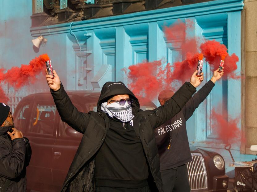 Protesters from Youth Demand and Palestine groups obstructing Tower Bridge in London with red smoke flares.