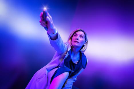 Jodie Whittaker as the Doctor, holding the sonic screwdriver.