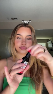Woman applying vanilla extract to her wrists.