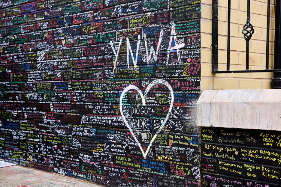 Tribute messages on a wall for Diogo Jota and Andre Silva.