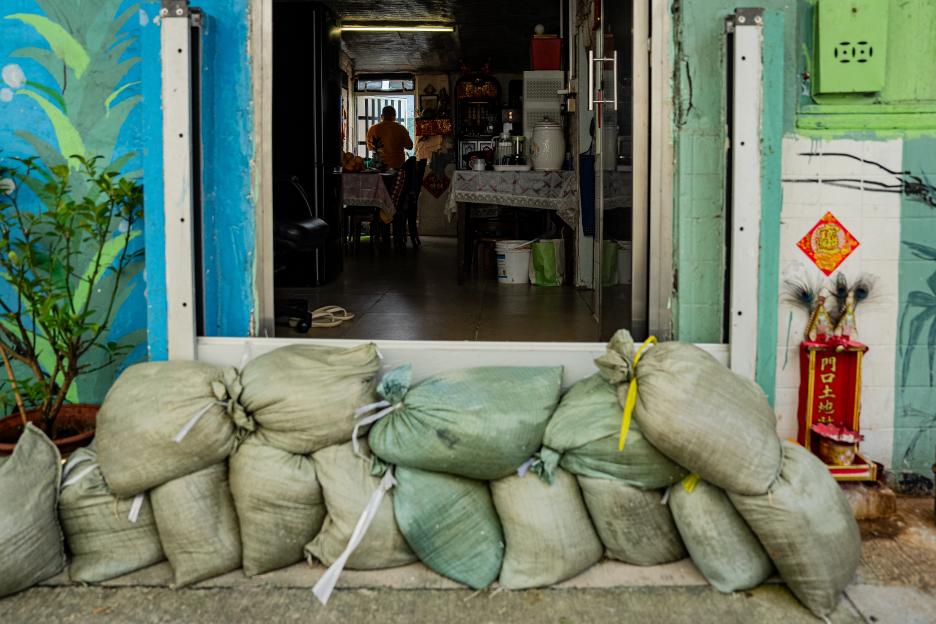 Sandbags placed in front of a shop entrance as a precaution against a typhoon.