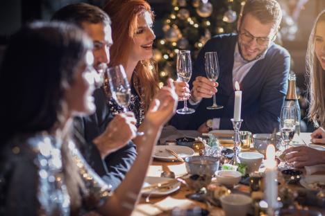 Friends enjoying a Christmas dinner party.