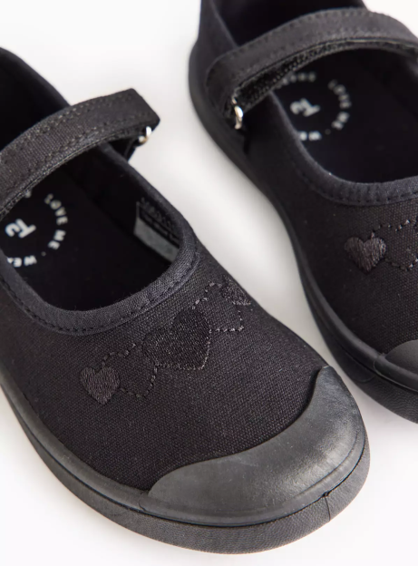 Black canvas Mary Janes with embroidered hearts.