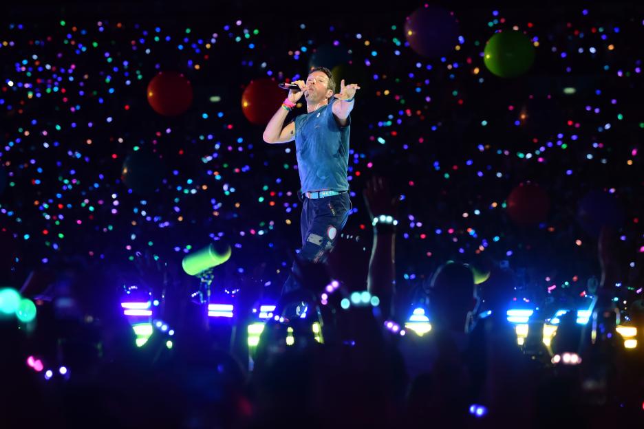 Chris Martin of Coldplay performing on stage.