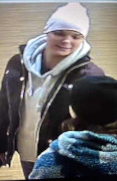 Amelia Murton in a white beanie, grey hooded top, and dark jacket.