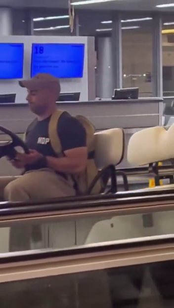 Man driving airport golf cart.