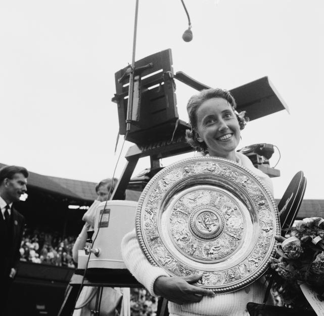 Angela Mortimer holding the Wimbledon ladies' singles trophy.