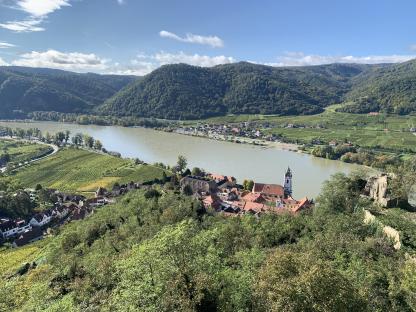 Aerial view of Durnstein, Austria, showing the Danube River, vineyards, and the town.