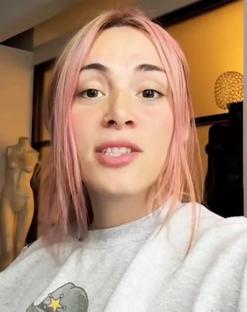 Woman with pink hair answering the question,