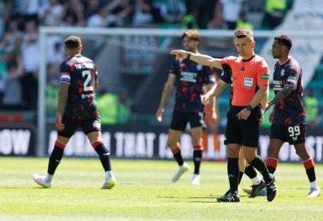 Referee signaling a goal during a soccer match.