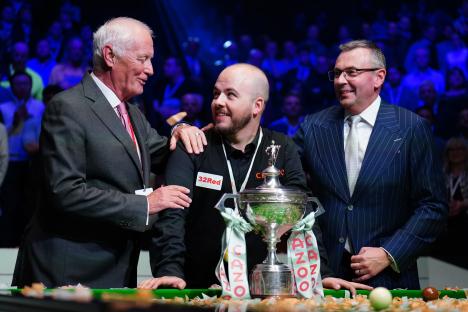 Snooker champion Luca Brecel with Barry Hearn and a trophy.