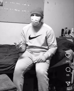 Black and white video of a man in prison, rapping.