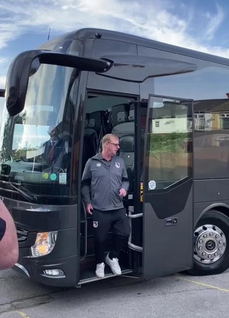 Grimsby team members boarding a bus.